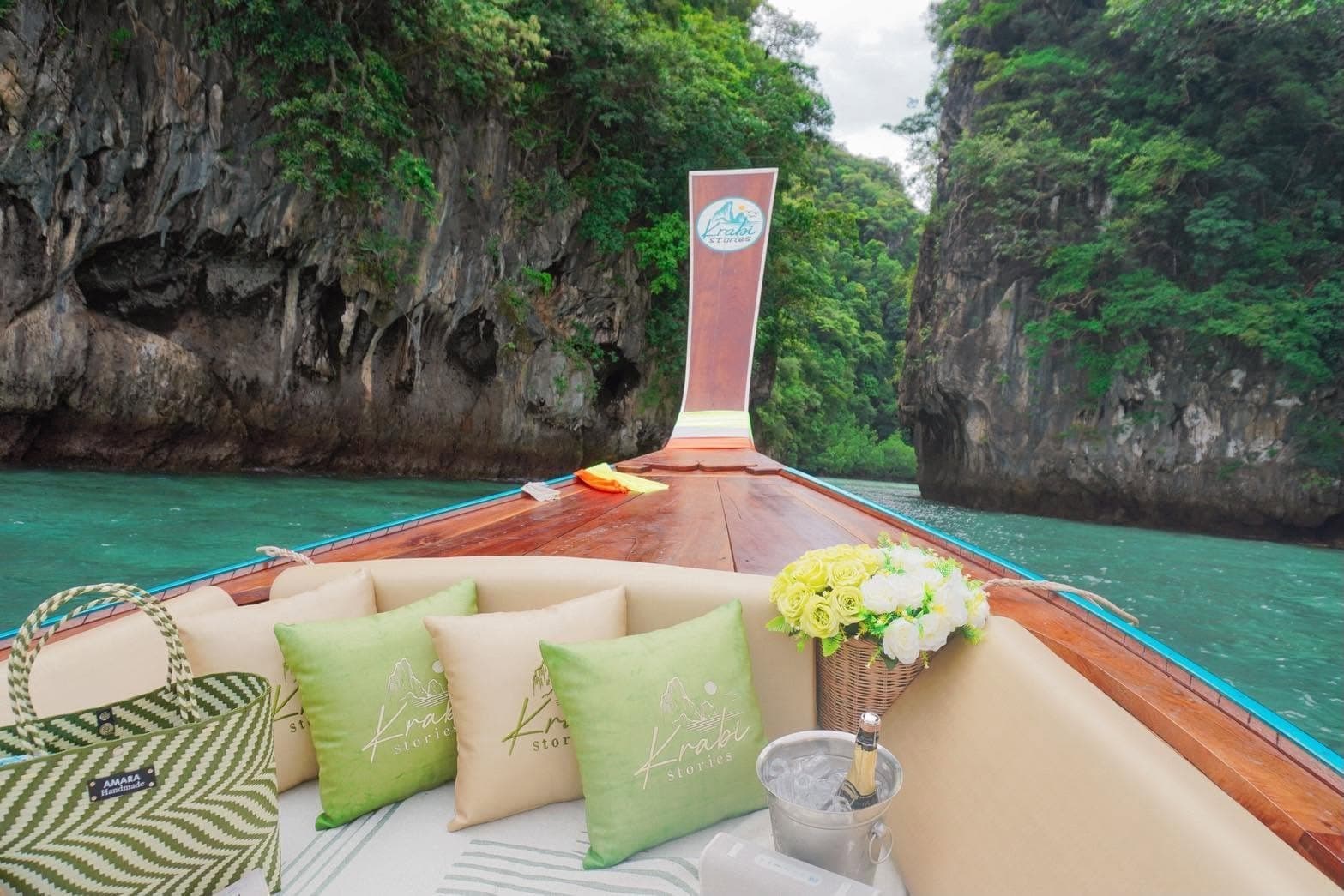 The bow of the longtail between limestone cliffs, cushions and chilled champagne ready